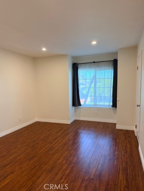 2500 East 4th Street, Unit 203 Long Beach, CA 90814 - Photo 22 of 35 an empty room with wooden floor and windows