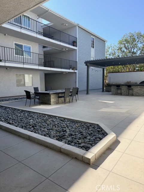 2500 East 4th Street, Unit 203 Long Beach, CA 90814 - Photo 27 of 35 a room with lots of furniture and a rug