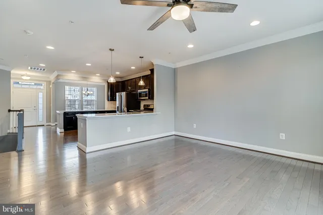 a view of a kitchen with a sink and a large window