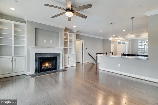 a view of an empty room and kitchen view