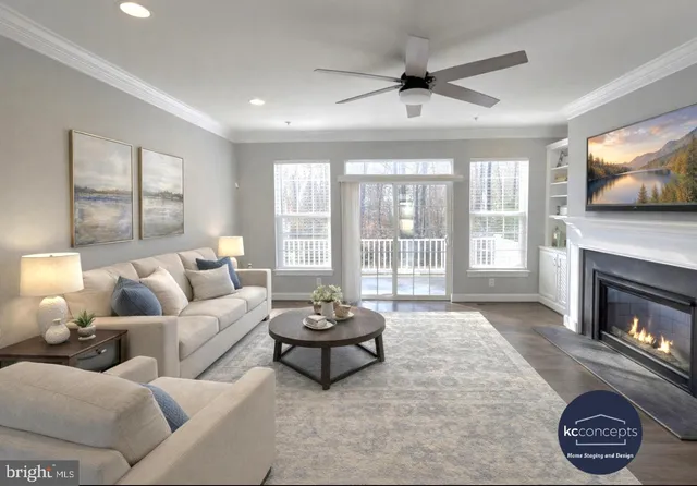 a living room with furniture a flat screen tv and a fireplace