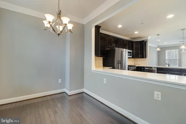 a view of a kitchen with a sink and refrigerator