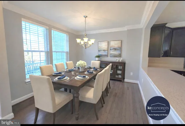 a view of a dining room with furniture wooden floor and chandelier