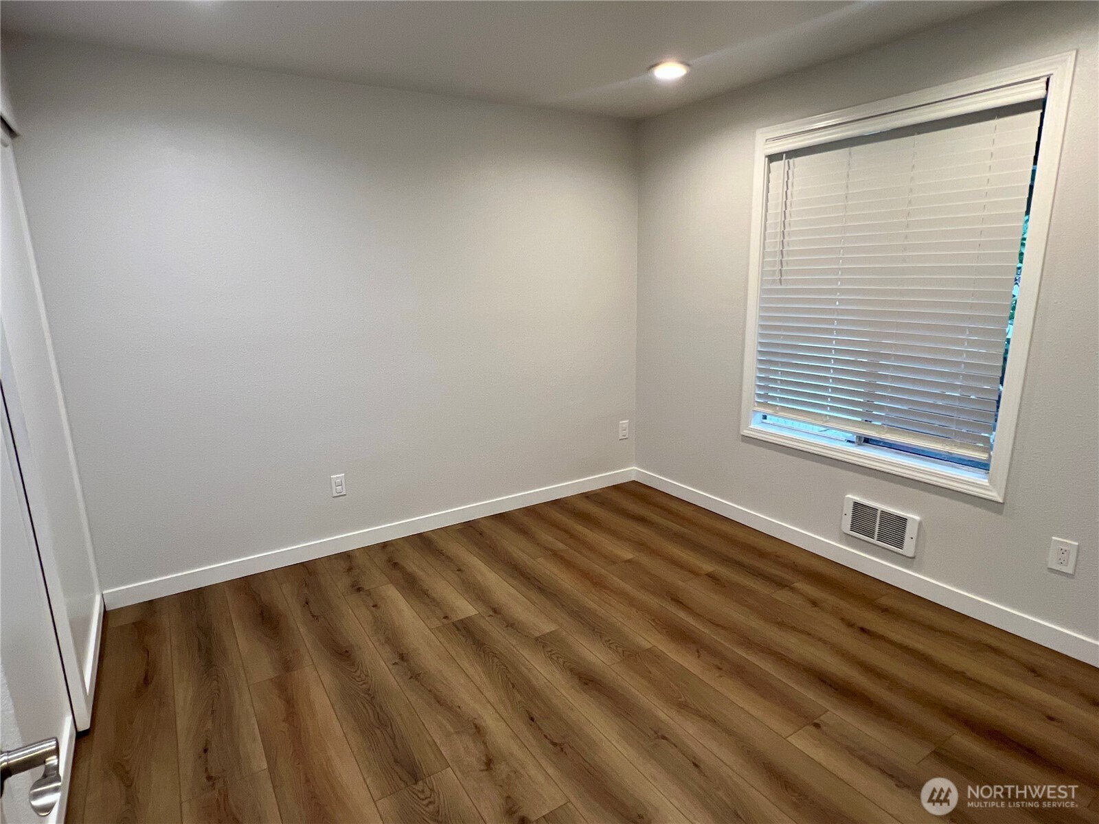526 South 323rd Place, Unit 11F Federal Way, WA 98003 - Photo 22 of 24 a view of an empty room with wooden floor and a window