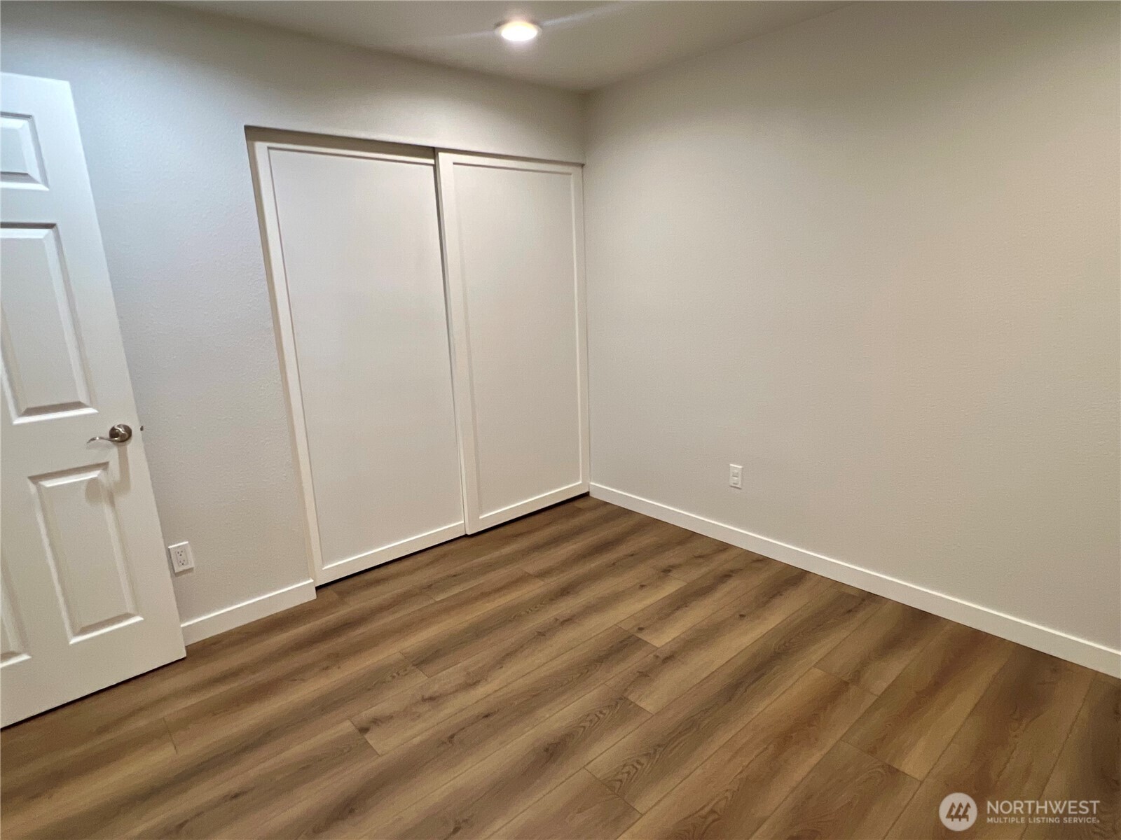 526 South 323rd Place, Unit 11F Federal Way, WA 98003 - Photo 23 of 24 a view of a room with wooden floor and white walls
