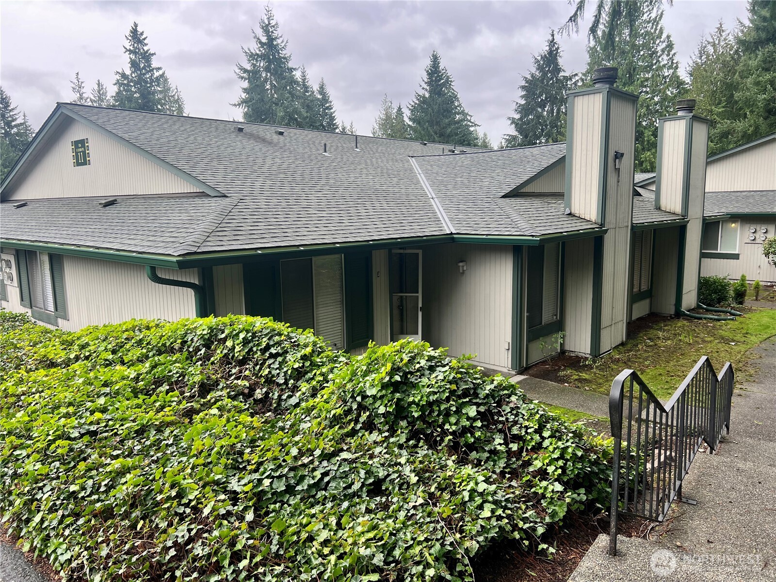 526 South 323rd Place, Unit 11F Federal Way, WA 98003 - Photo 24 of 24 a front view of a house with garden