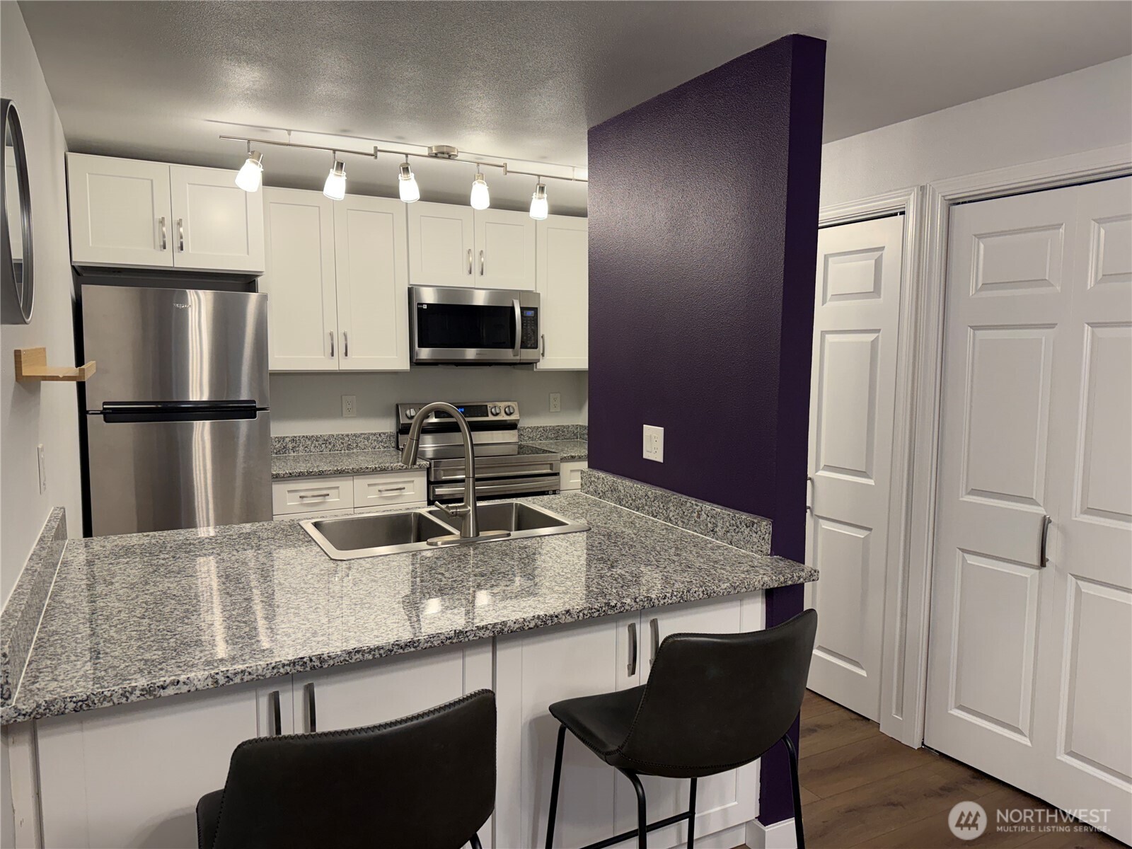 526 South 323rd Place, Unit 11F Federal Way, WA 98003 - Photo 8 of 24 a kitchen with stainless steel appliances granite countertop a sink refrigerator and microwave