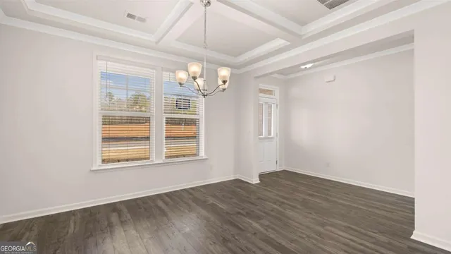 a kitchen with stainless steel appliances granite countertop a sink a microwave oven a refrigerator and white cabinets with wooden floor