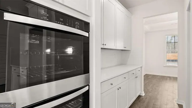 a view of an empty room with a fireplace and a window
