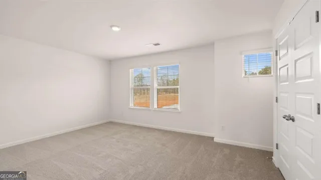 an aerial view of residential houses with outdoor space and trees