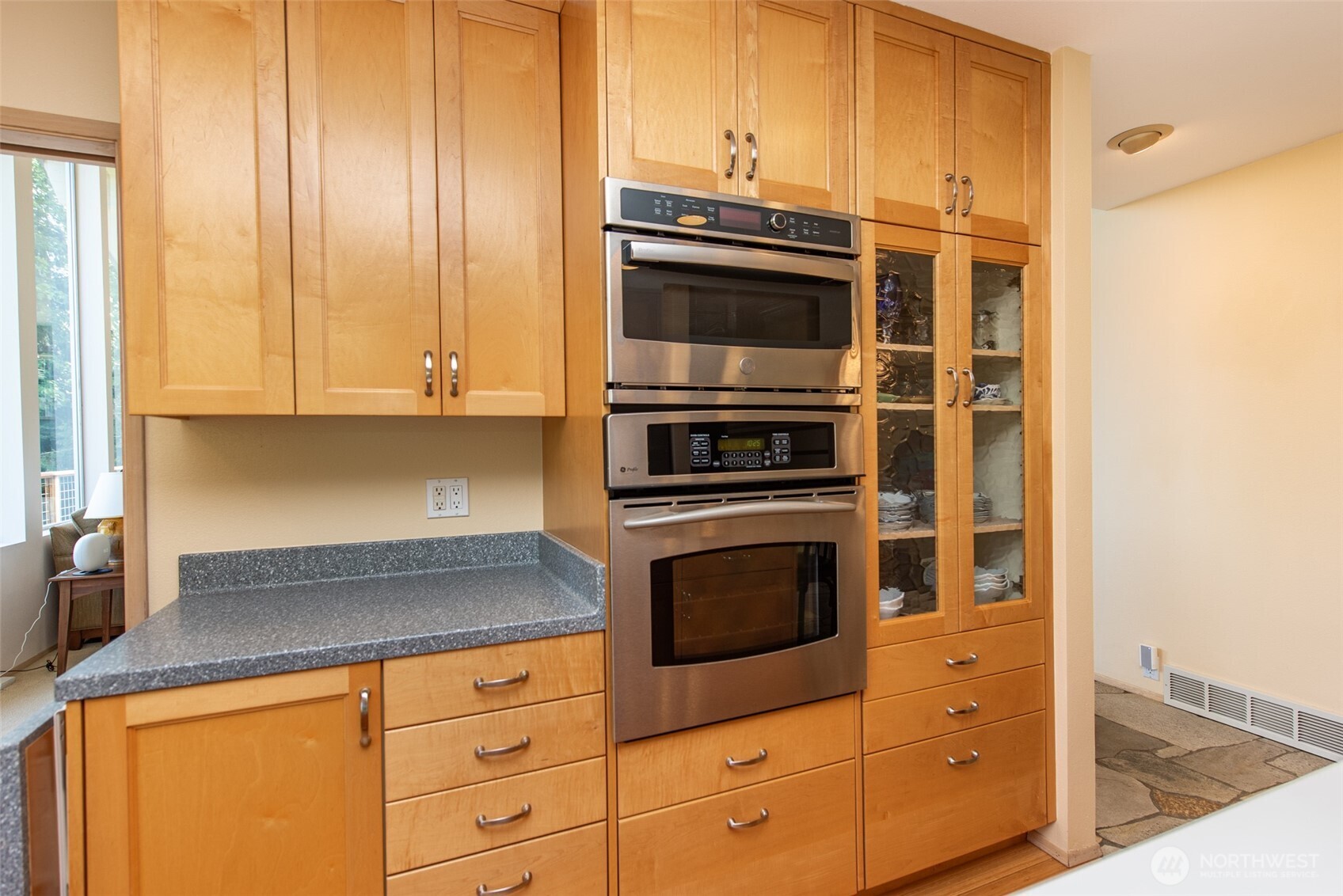 322 Ravens Ridge Road Sequim, WA 98382 - Photo 11 of 40 a kitchen with granite countertop white cabinets and stainless steel appliances