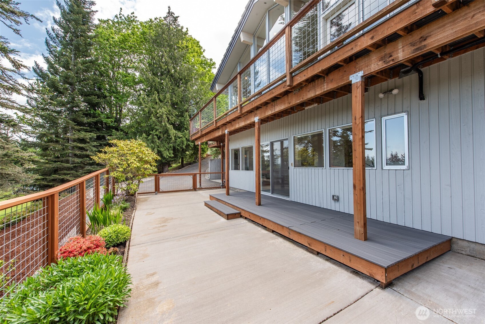 322 Ravens Ridge Road Sequim, WA 98382 - Photo 26 of 40 a view of a house with large windows and plants