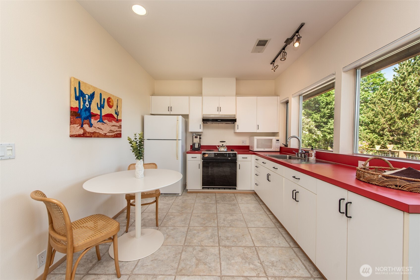 322 Ravens Ridge Road Sequim, WA 98382 - Photo 29 of 40 a open kitchen with stainless steel appliances granite countertop a stove a sink a dining table and chairs
