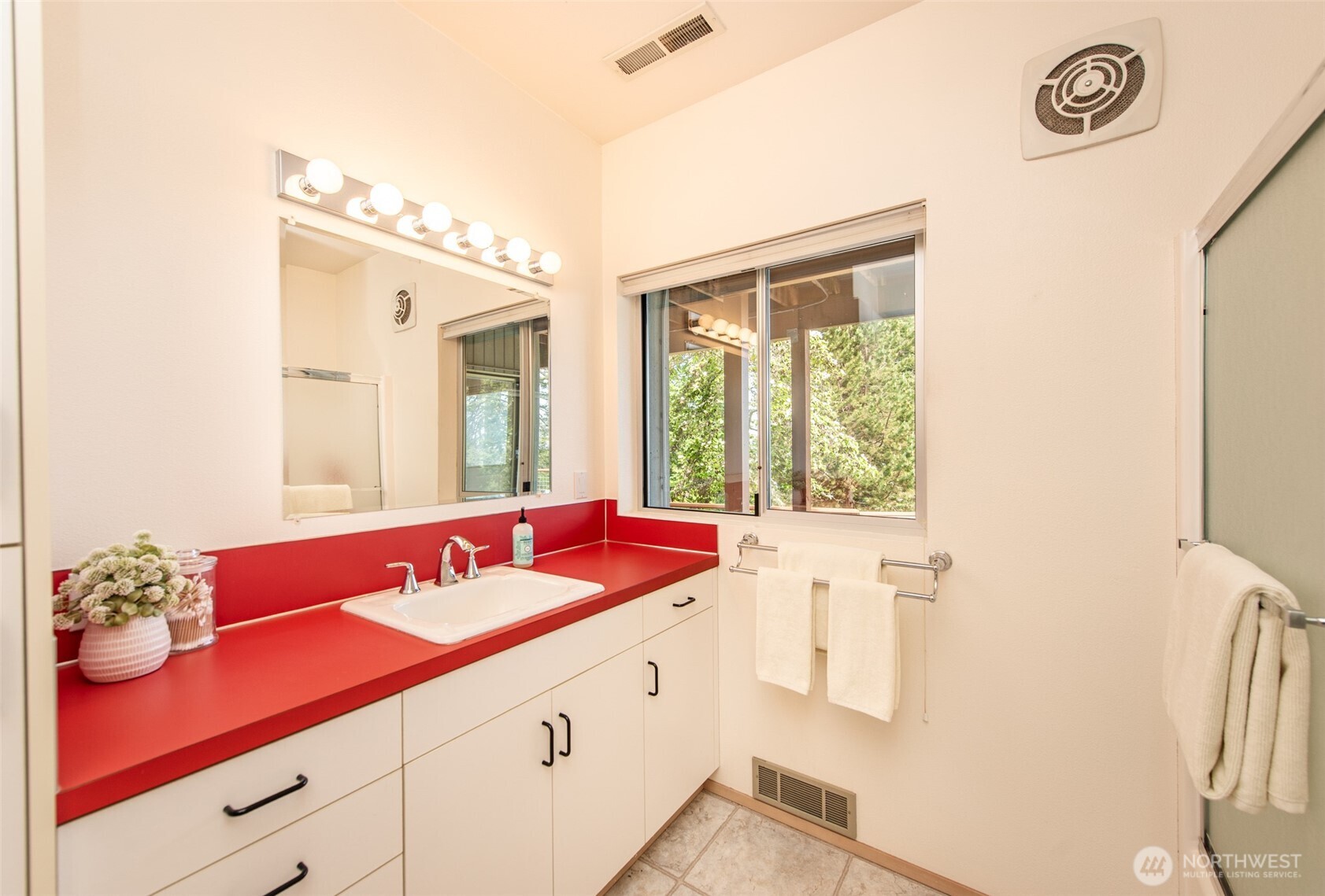 322 Ravens Ridge Road Sequim, WA 98382 - Photo 32 of 40 a bathroom with a sink and a large mirror