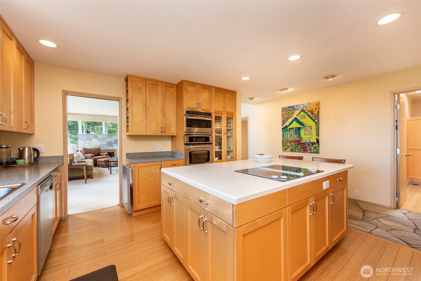 322 Ravens Ridge Road Sequim, WA 98382 - Photo 9 of 40 a kitchen that has a lot of cabinets in it and wooden floors