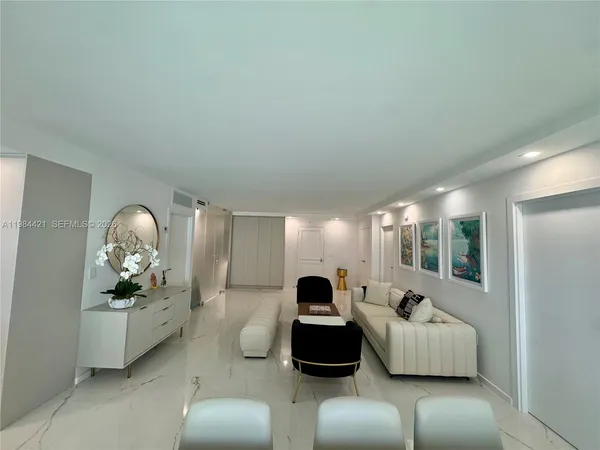 a living room with furniture and a large mirror