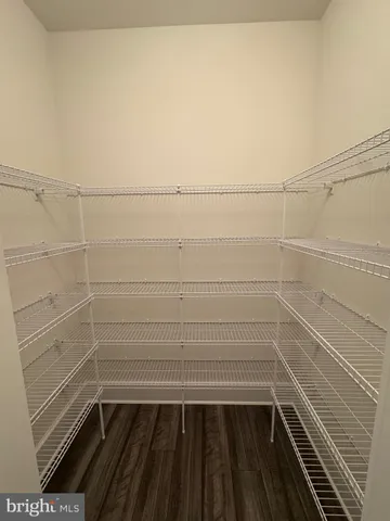 a hallway with closet and wooden floor