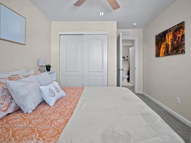 a bedroom with a large bed and a chandelier
