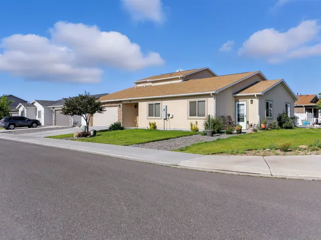a view of house with a garden and tall tress