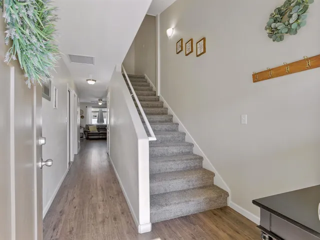 a view of entryway and hall with wooden floor