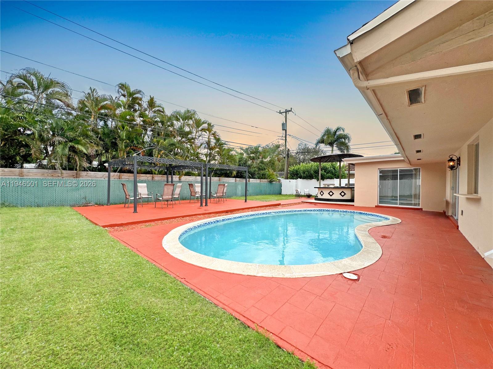 a view of a swimming pool with a yard