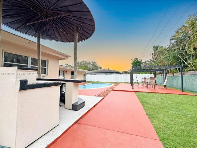 a view of a backyard with swimming pool