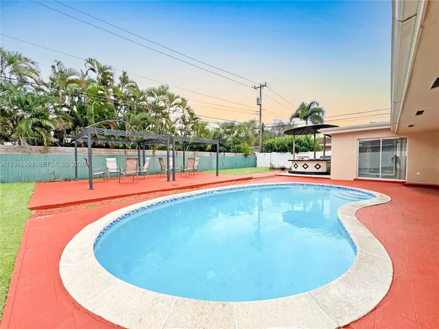 a view of a swimming pool with an outdoor seating
