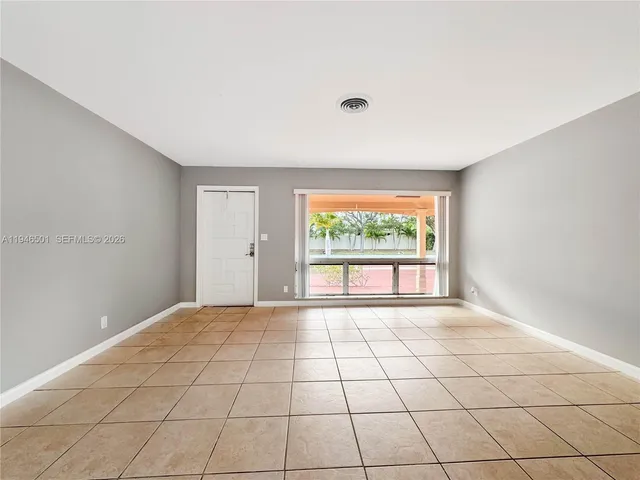 a view of an empty room with a window
