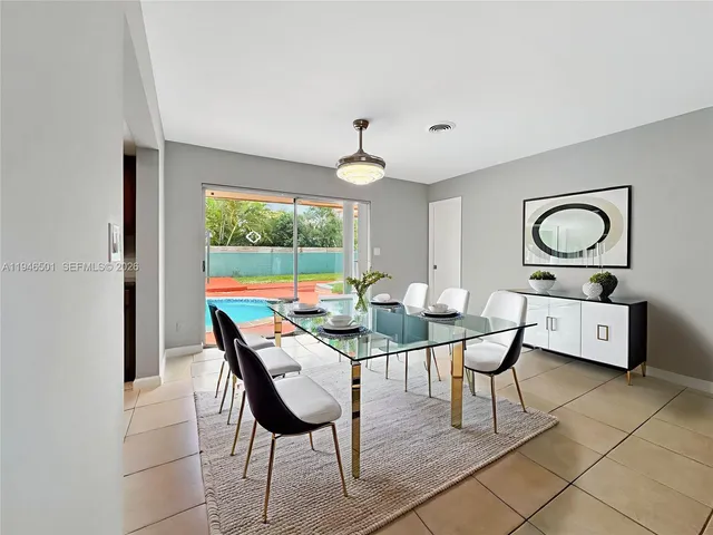a living room with furniture a window and a chandelier