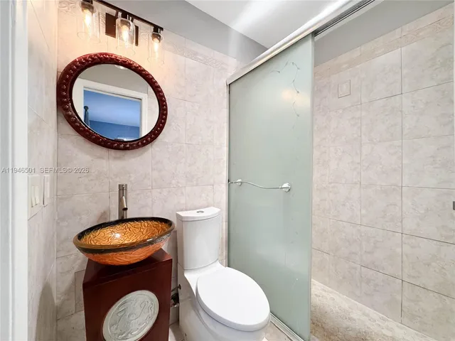 a bathroom with a toilet and a mirror