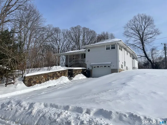 a view of a house with a snow in the yard
