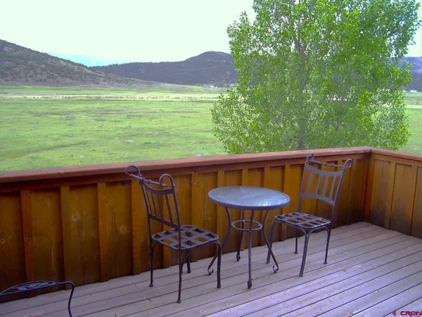 a view of a outdoor sitting area with furniture and wooden floor