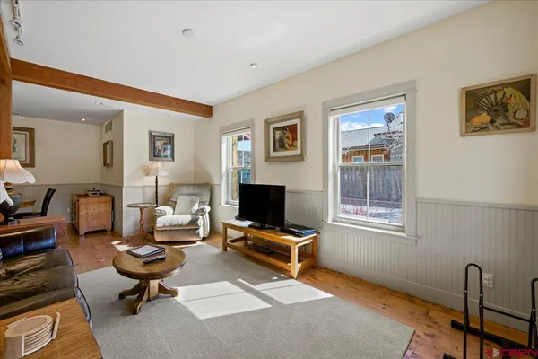 a living room with furniture gym equipment and a window