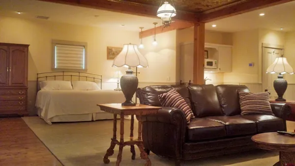 a living room with furniture and a chandelier