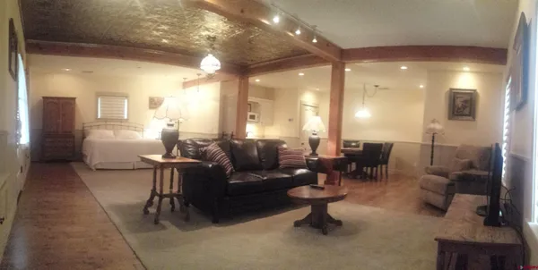 a living room with furniture and a potted plant