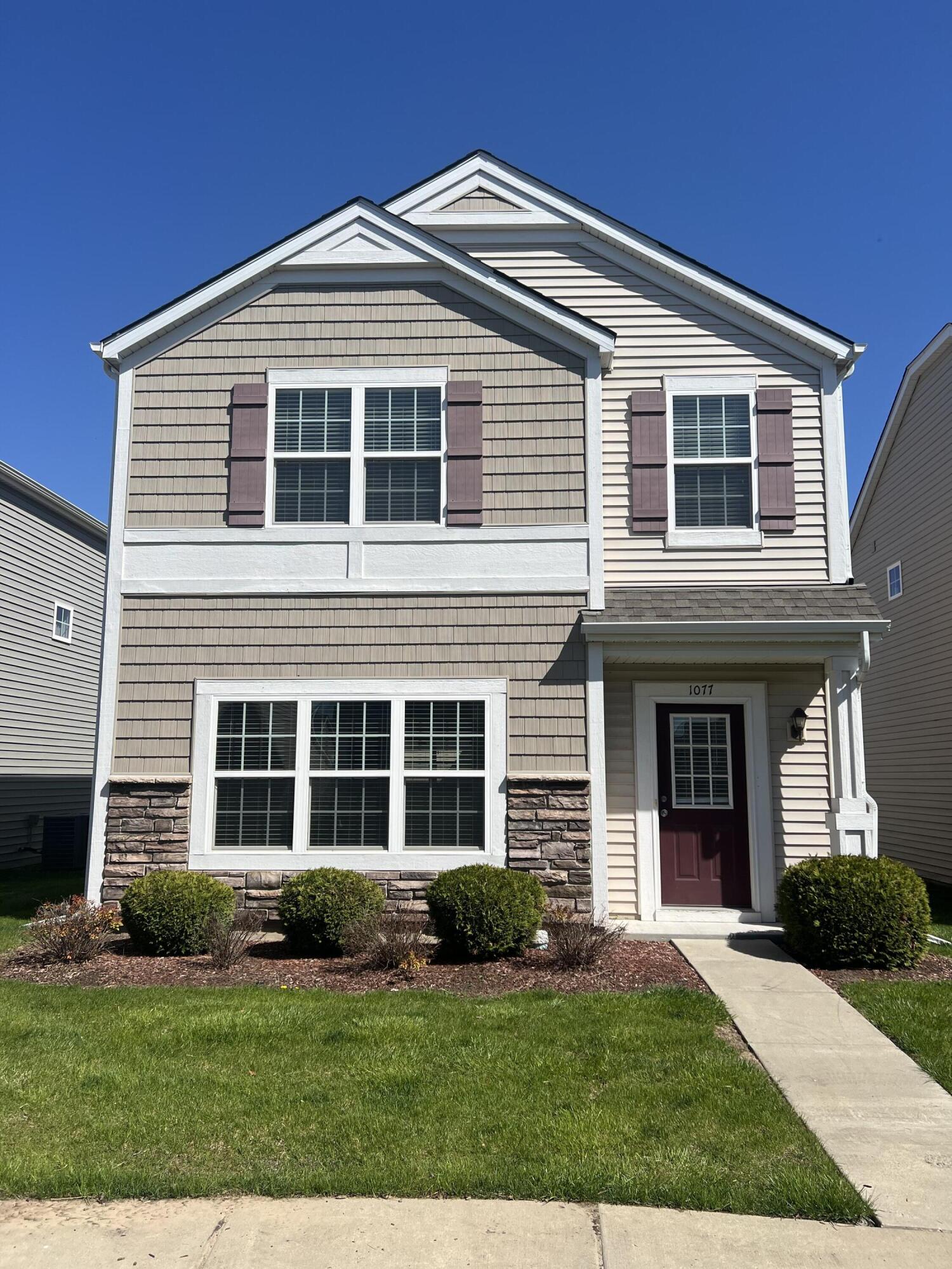 1077 East 115th Lane Crown Point, IN 46307 - Photo 1 of 16 a front view of a house with a yard