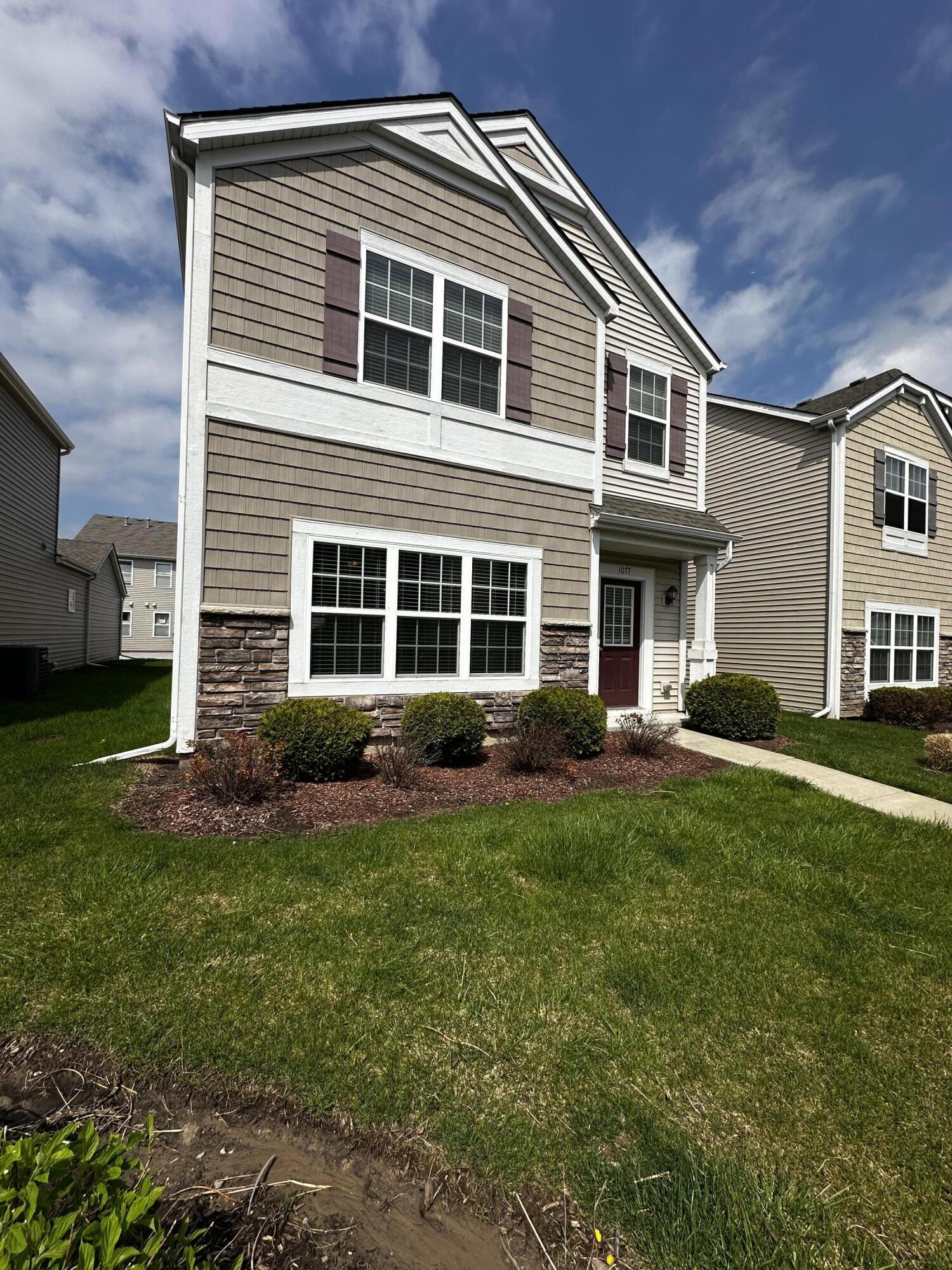 1077 East 115th Lane Crown Point, IN 46307 - Photo 2 of 16 a front view of a house with a yard