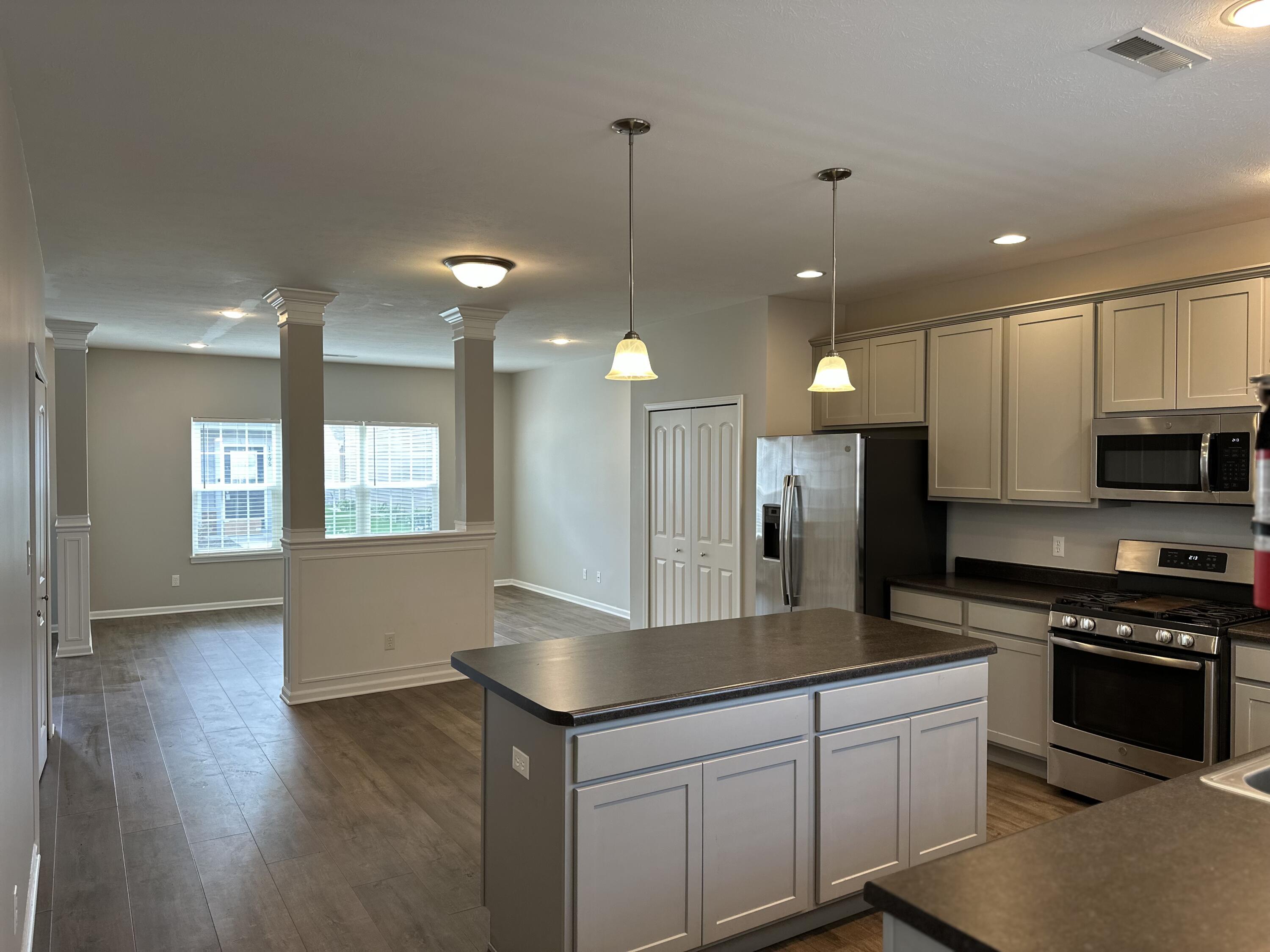 1077 East 115th Lane Crown Point, IN 46307 - Photo 3 of 16 a kitchen with kitchen island a counter space a sink and appliances