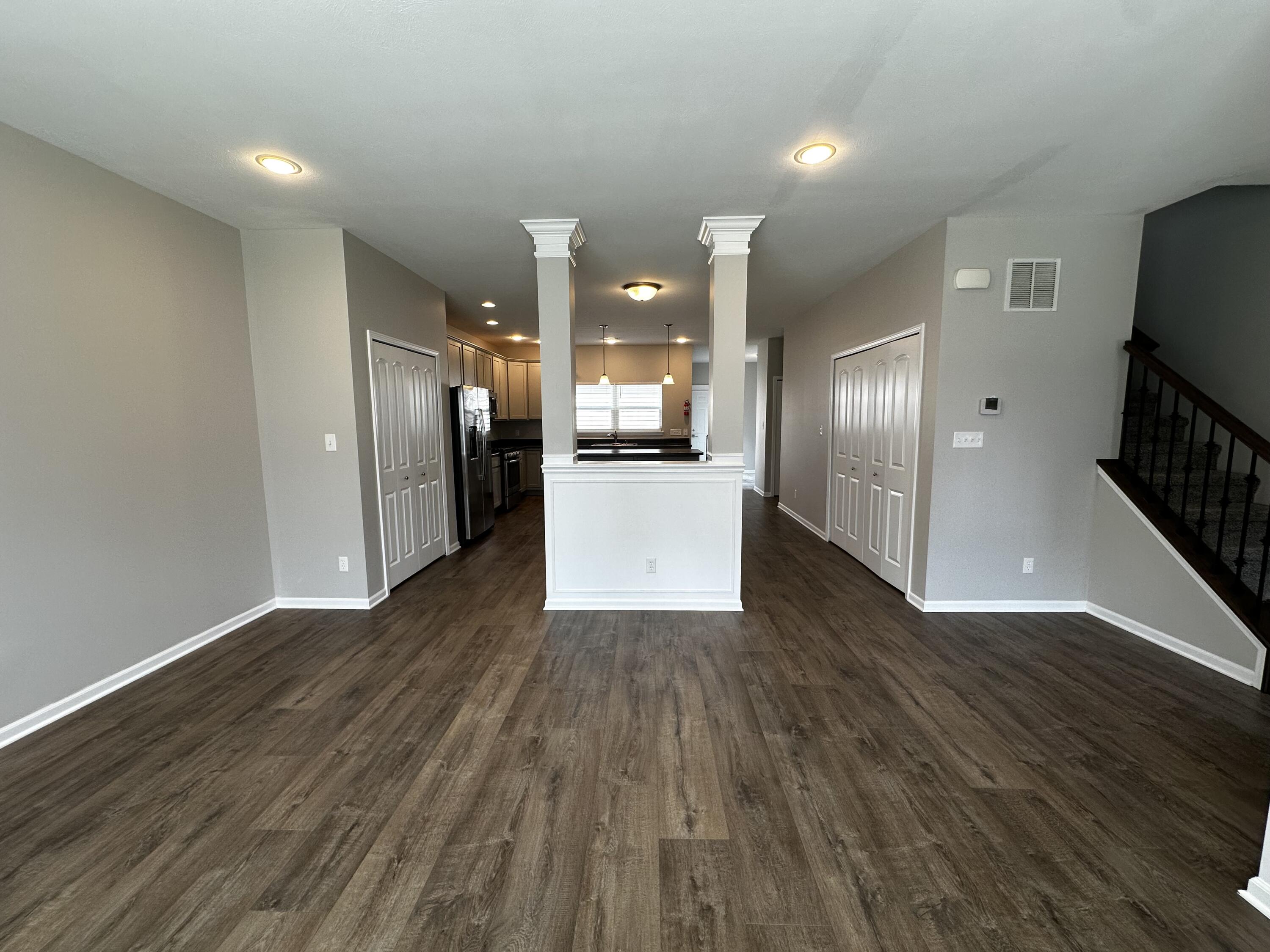 1077 East 115th Lane Crown Point, IN 46307 - Photo 5 of 16 a view of a refrigerator in kitchen and wooden floor