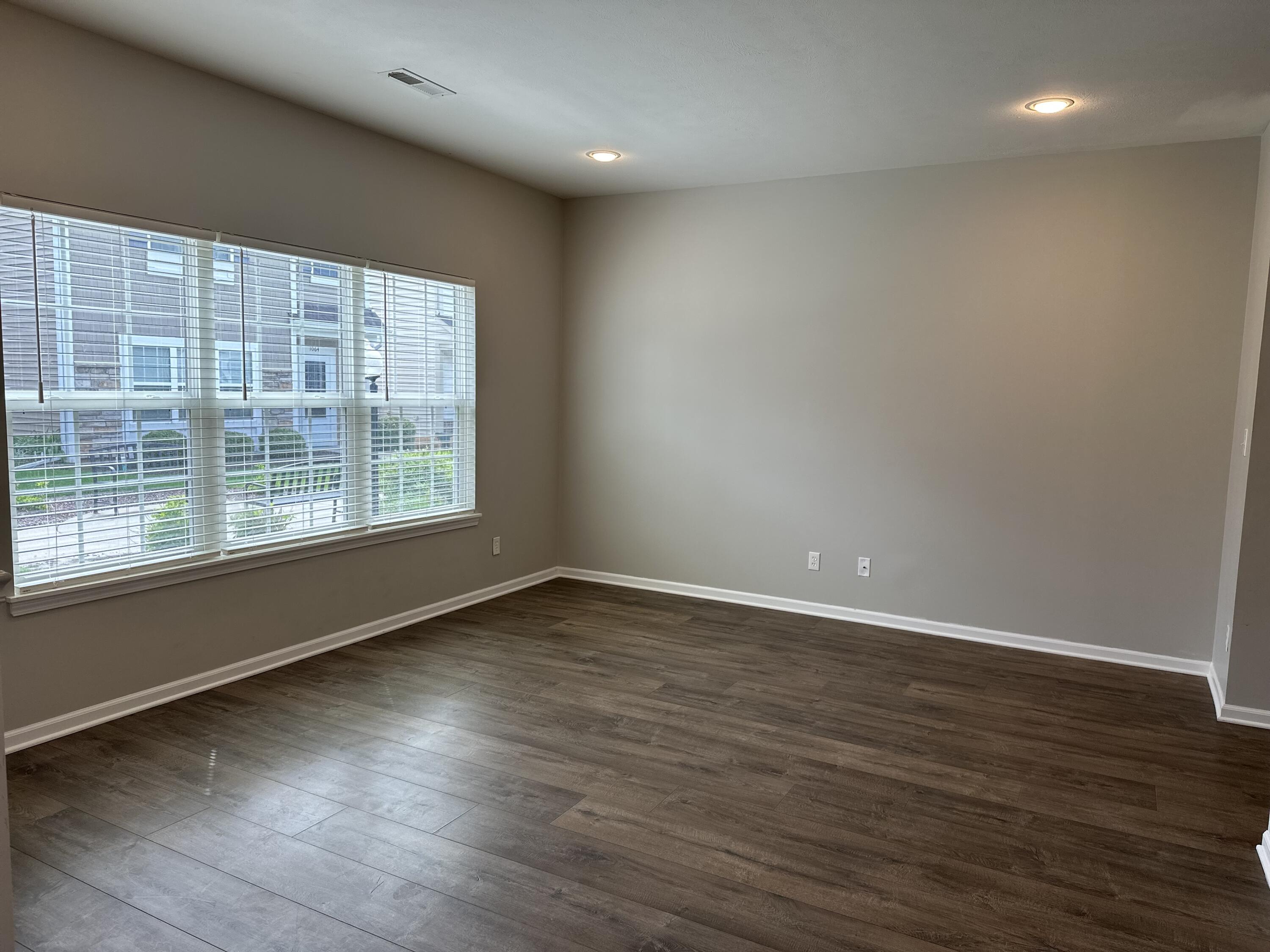 1077 East 115th Lane Crown Point, IN 46307 - Photo 6 of 16 wooden floor in an empty room with a window