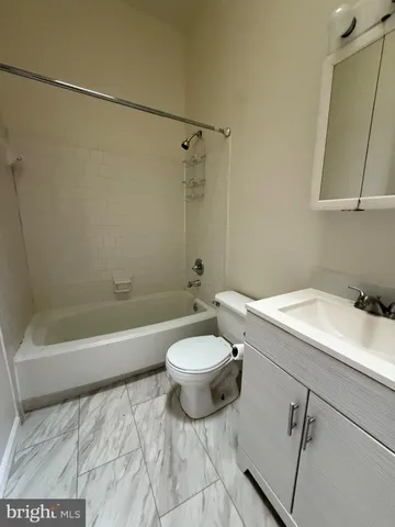 a bathroom with a sink a toilet and a bathtub