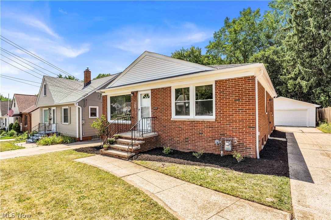 4322 Roadoan Road Brooklyn, OH 44144 - Photo 2 of 27 View of front of house featuring a garage, an outdoor structure, and a front yard
