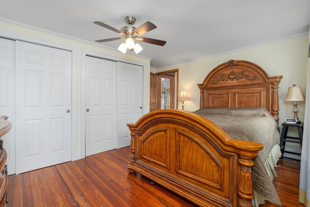 6 Hayes Avenue Beverly, MA 01915 - Photo 13 of 24 a bedroom with a bed and a chandelier