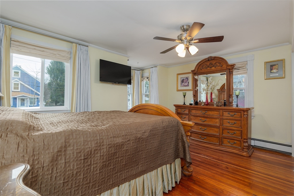 6 Hayes Avenue Beverly, MA 01915 - Photo 14 of 24 a bedroom with a bed a dresser and flat screen tv