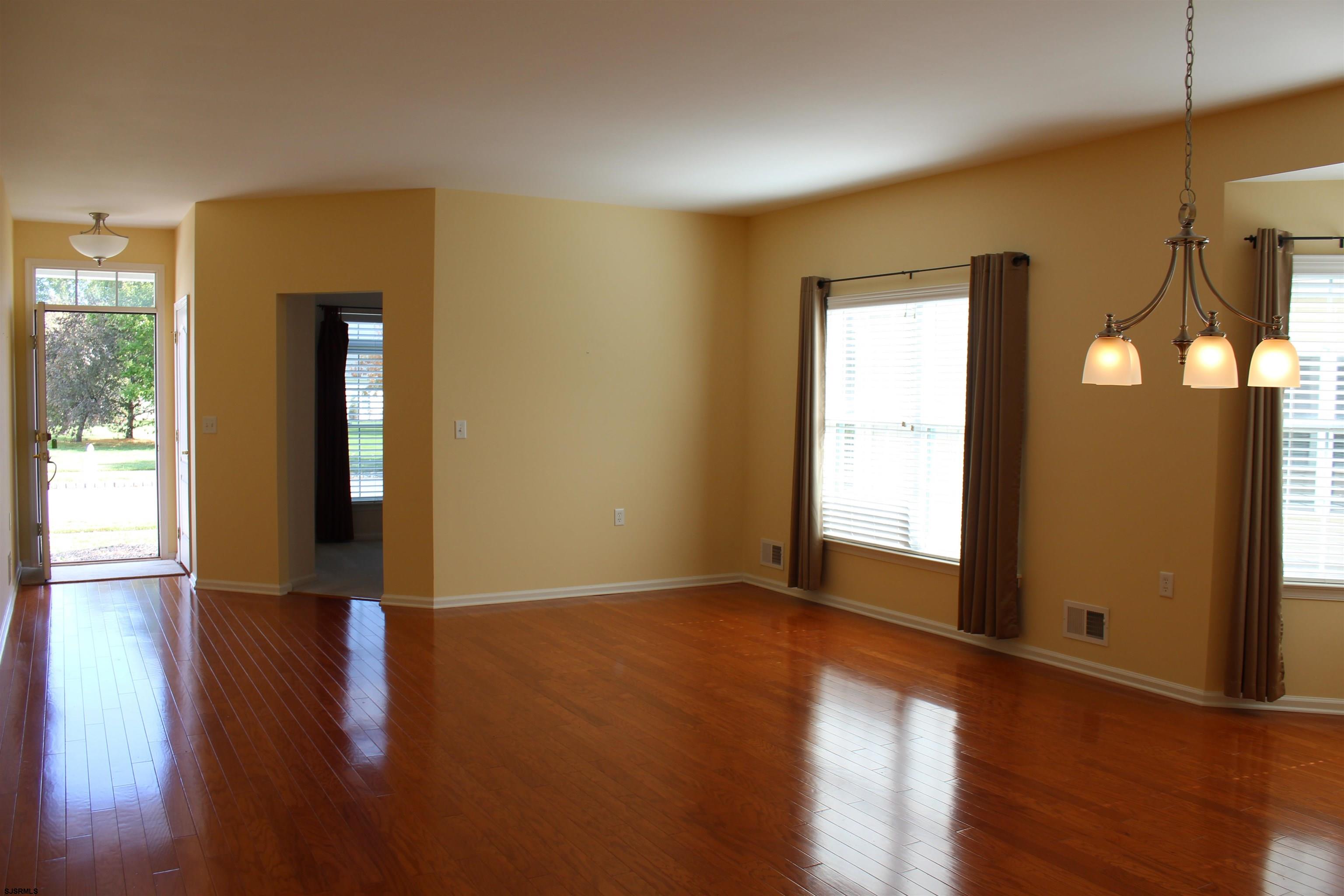 39 Poppy Road Egg Harbor Township, NJ 08234 - Photo 2 of 37 a view of an empty room with wooden floor and a window