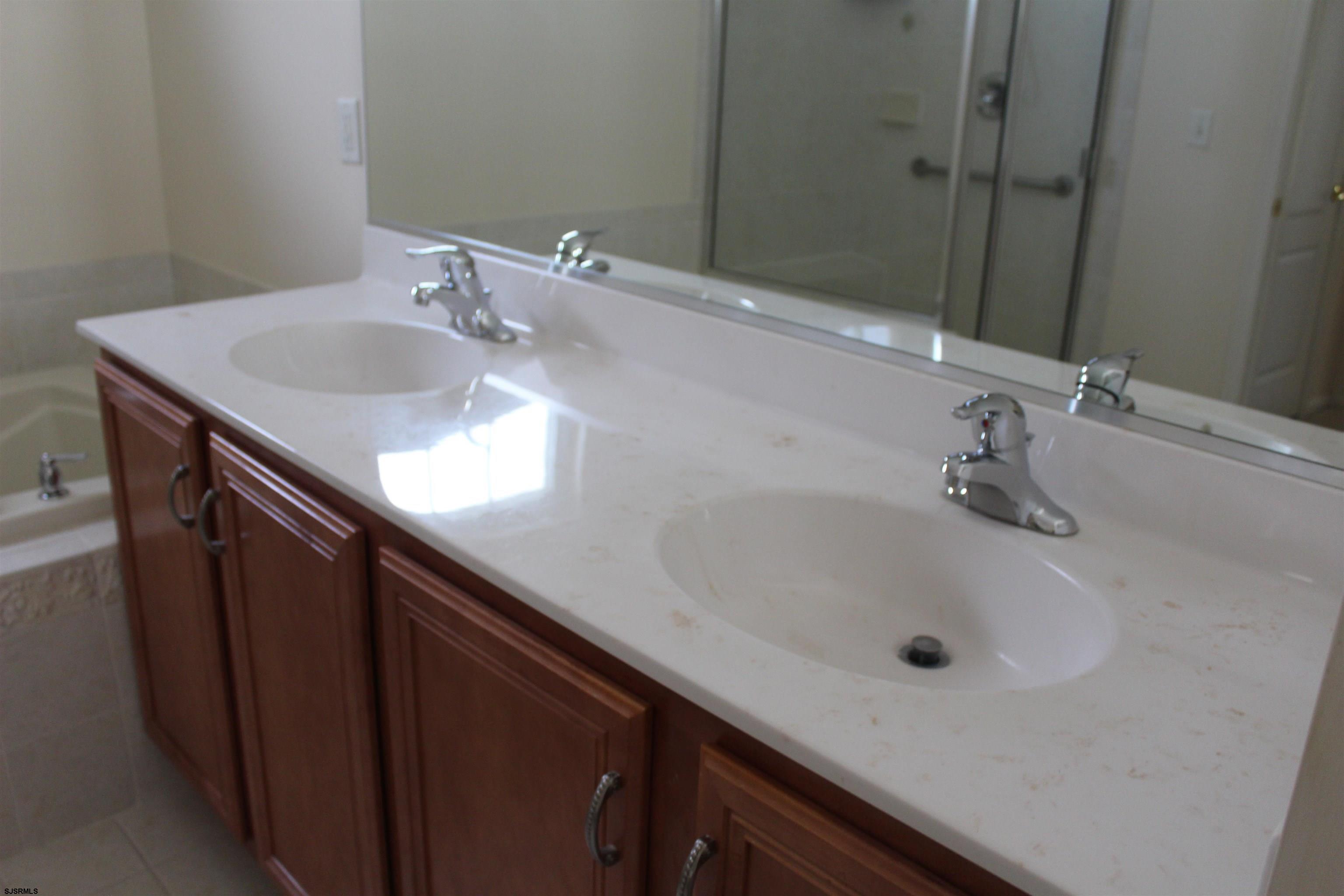 39 Poppy Road Egg Harbor Township, NJ 08234 - Photo 21 of 37 a bathroom with a sink and a mirror