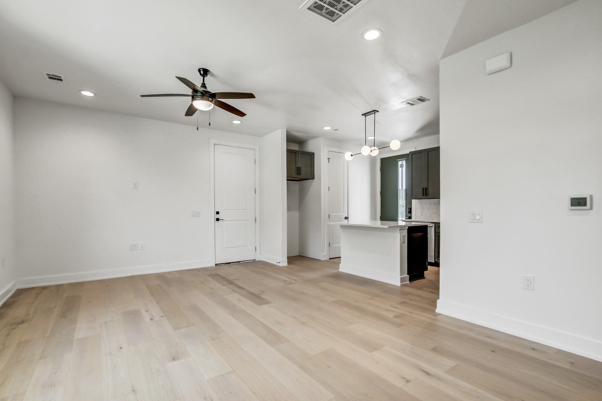 4127 East 12th Street, Unit 3 Austin, TX 78721 - Photo 8 of 29 Unfurnished living room featuring recessed lighting, ceiling fan, baseboards, and light wood-type flooring