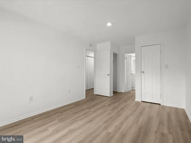 a view of an empty room and wooden floor