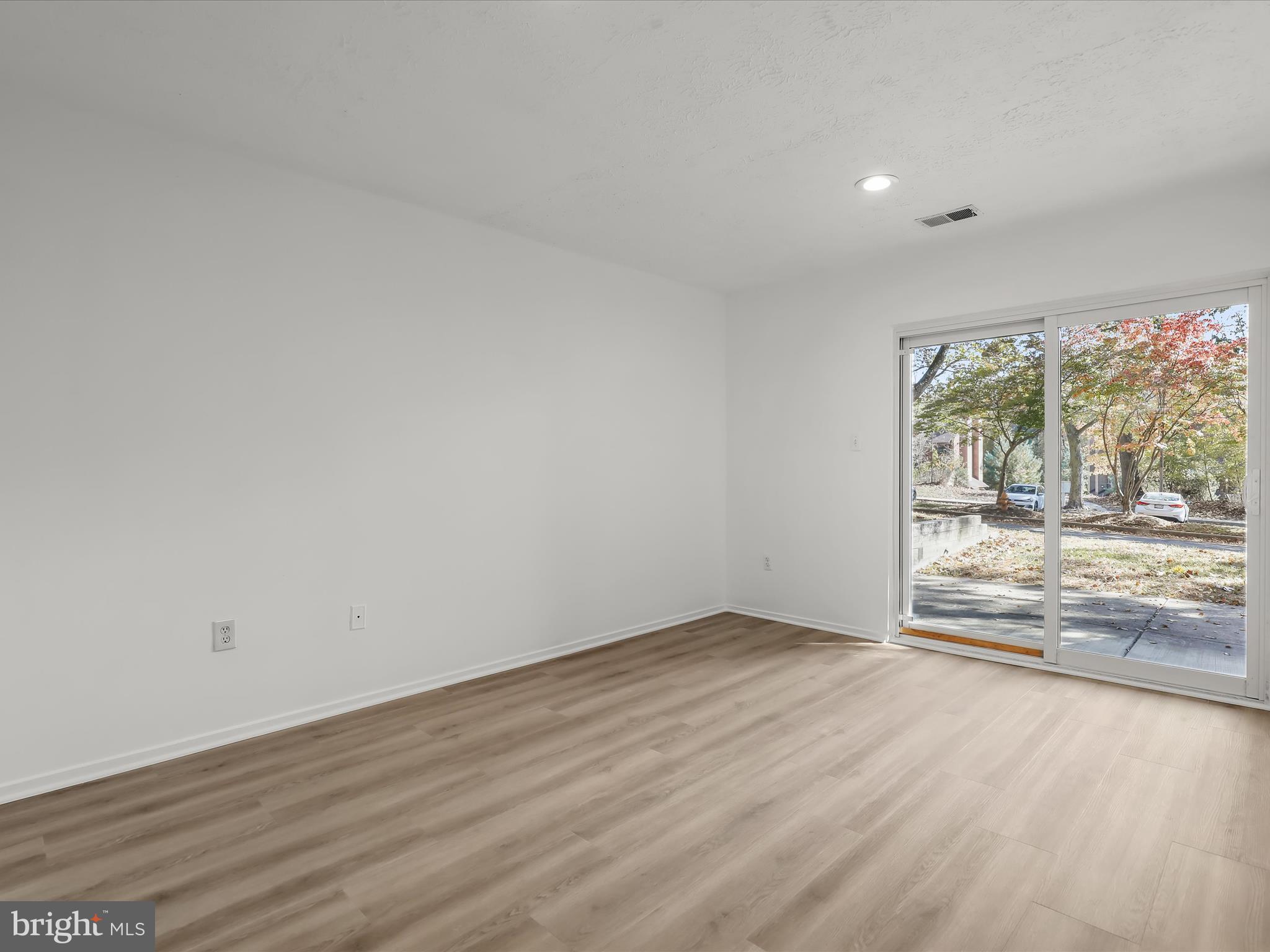 7517 Weather Worn Way, Unit A Columbia, MD 21046 - Photo 15 of 27 wooden floor in an empty room with a window