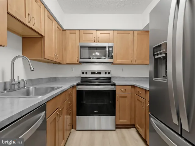 an empty room with wooden floor and a window